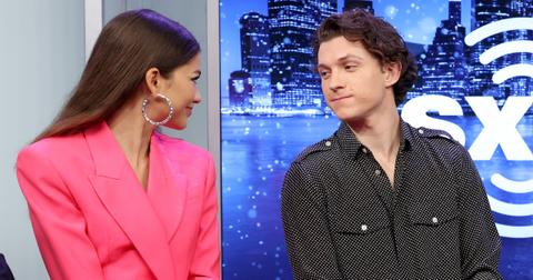 Zendaya and Tom Holland looking at each other during an interview.