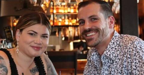 Jessica and Crag sit beside each other in a restaurant