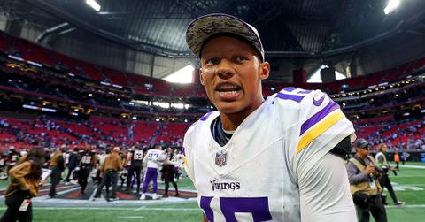 Josh Dobbs in a Vikings hat and uniform.