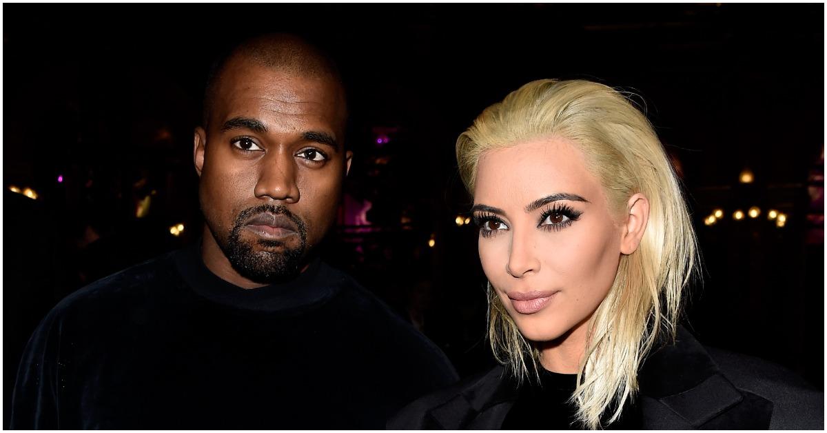 (l-r): Kanye West and Kim Kardashian posing at an event in all-black outfits. 