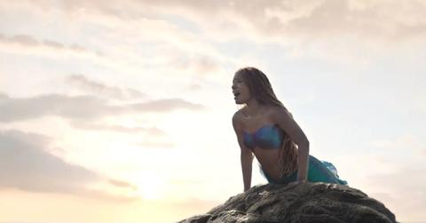 Halle Bailey as Ariel sitting on a rock in 'The Little Mermaid' 2023