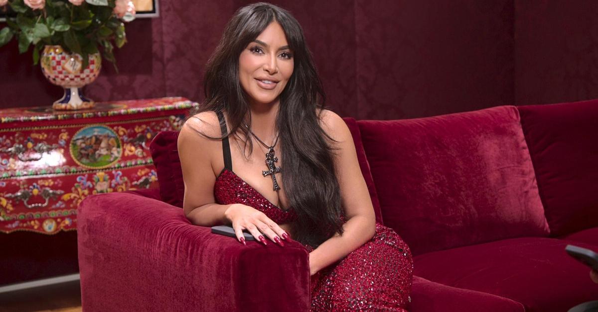 Kim Kardashian on a red velvet couch