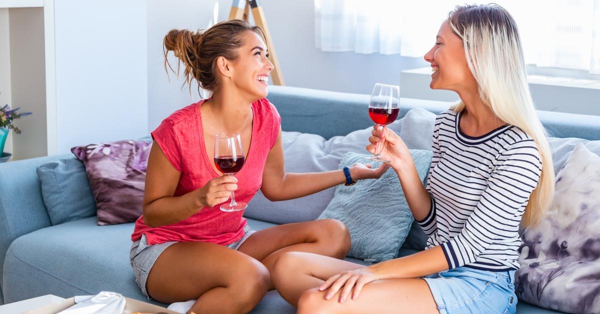 Two women drink wine