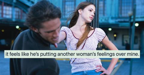 woman angrily pushing guy away