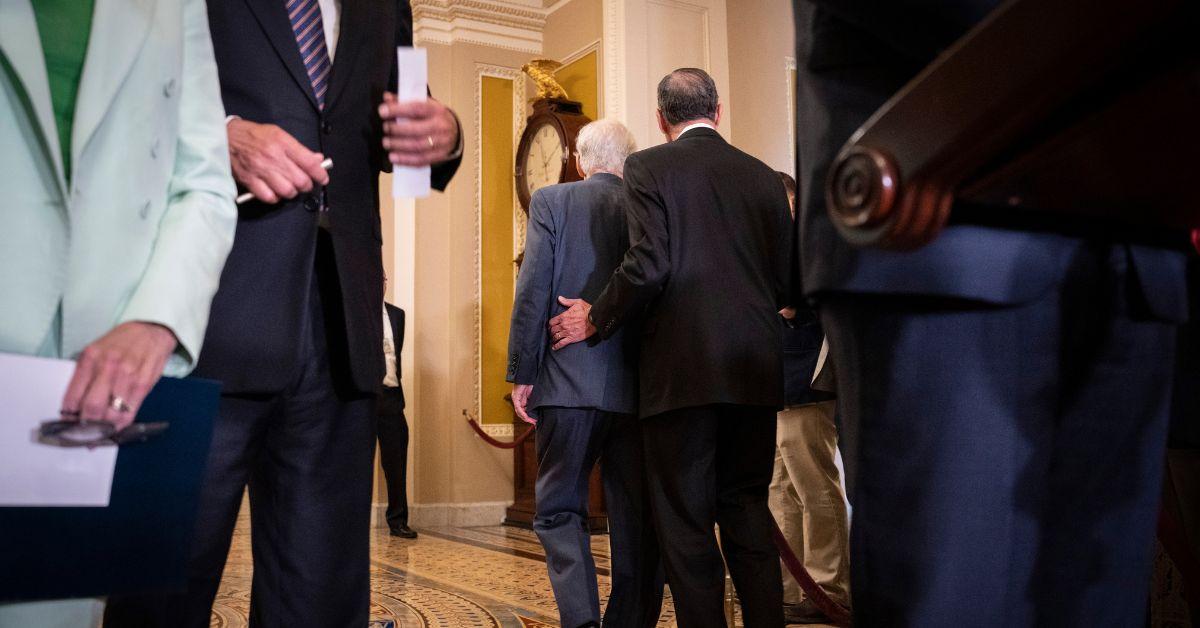 Senator Mitch McConnell is escorted away from a press conference at the U.S. Capitol.