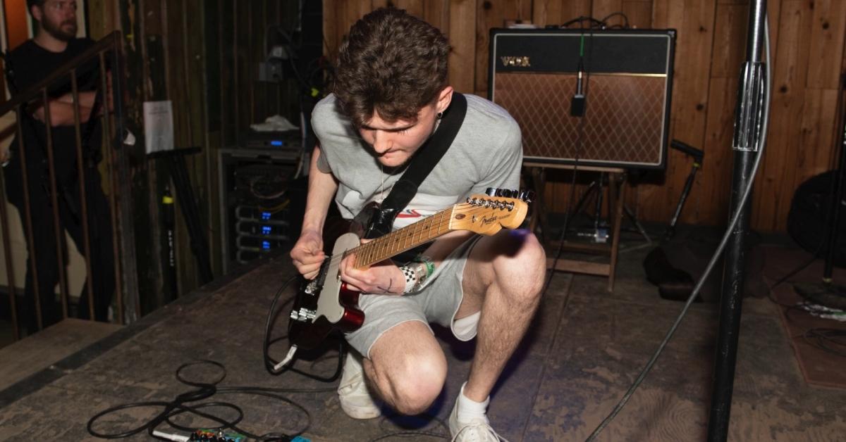 Matt Kwasniewski-Kelvin playing guitar