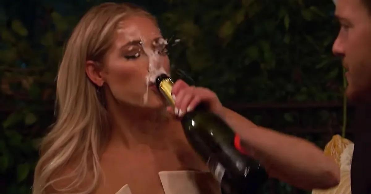 Kelsey Weier is sprayed in the face while attempting to chug a bottle of champagne during a date on 'The Bachelor'