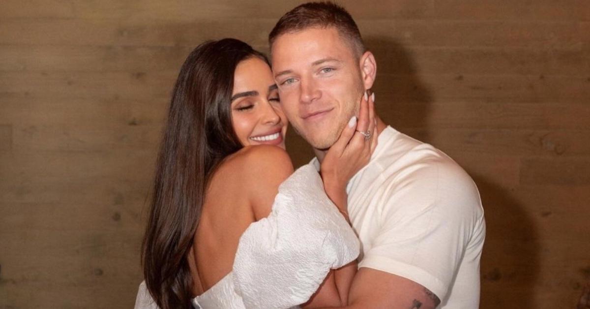 Christian McCaffrey and Olivia Culpo embracing each other.