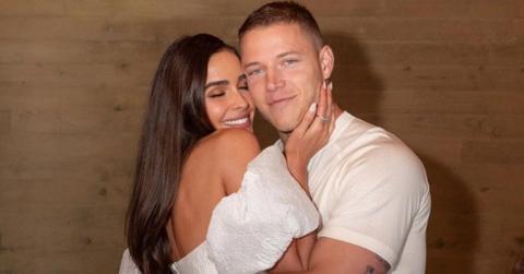 Christian McCaffrey and Olivia Culpo embracing each other.