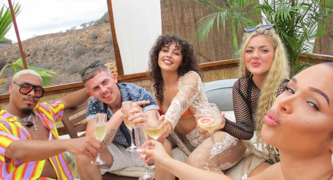 The cast of 'Ex on the Beach Couples' toasting with drinks by the pool