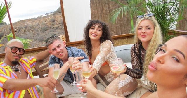 The cast of 'Ex on the Beach Couples' toasting with drinks by the pool