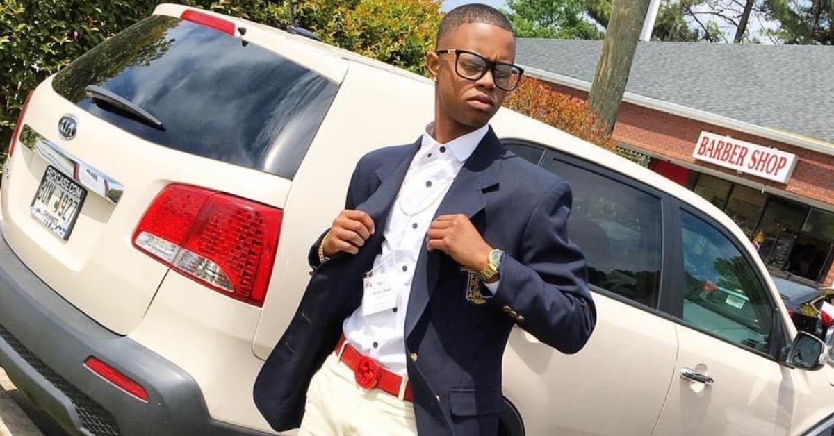 Silentó stands in front of a car