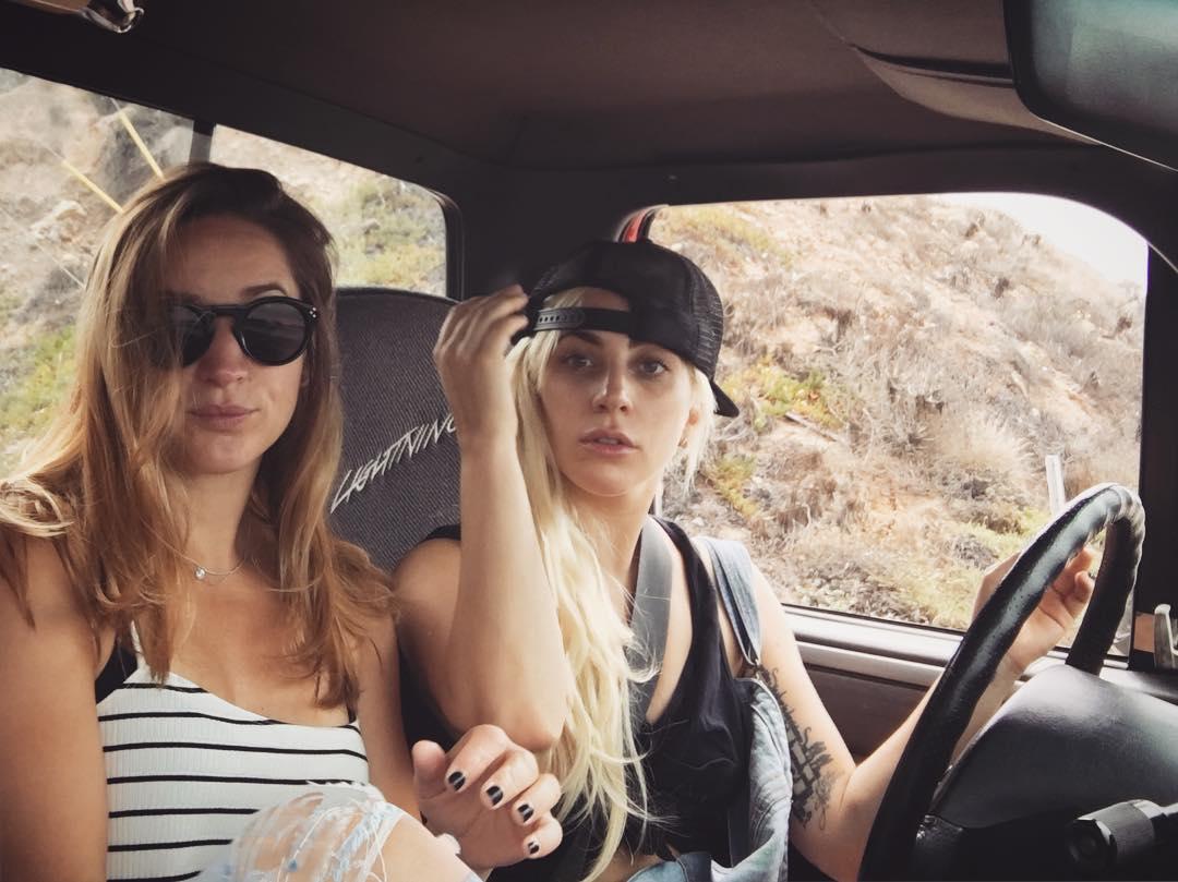 Lady Gaga and a friend sit in a car with the singer behind the wheel in 2016