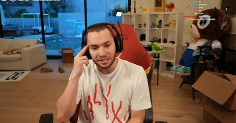 Adin Ross streaming while wearing a headset.