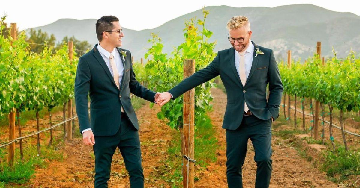 (l-r): Armando Niedermeier-Rubio and Kenny Niedermeier holding hands at their wedding