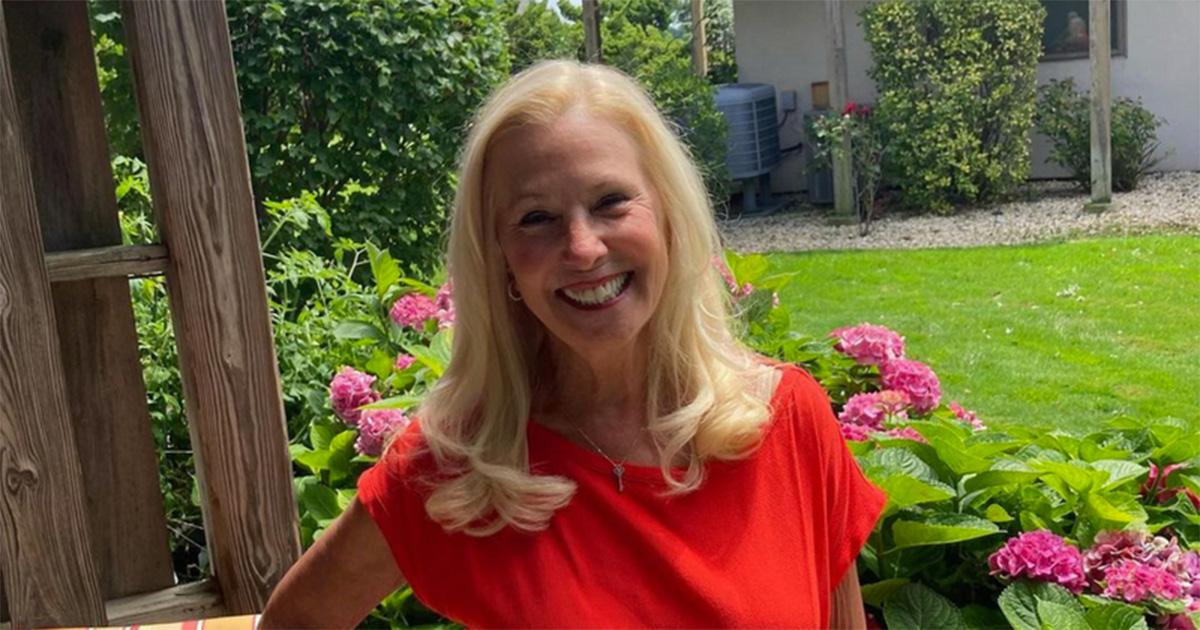 Ellen Goltzer in a red shirt in a garden. 