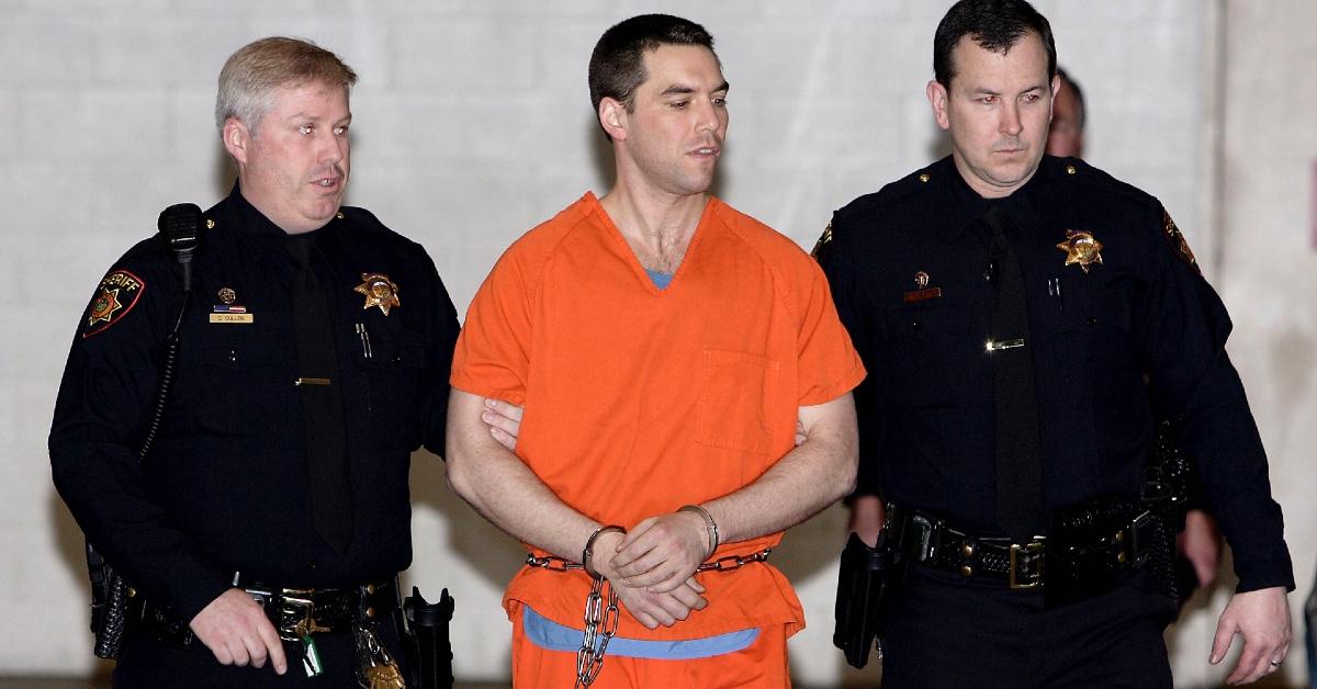 Scott Peterson detailed and being guided by law enforcement officials.