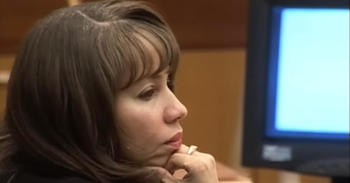 Dionne Baugh sits in a courtroom