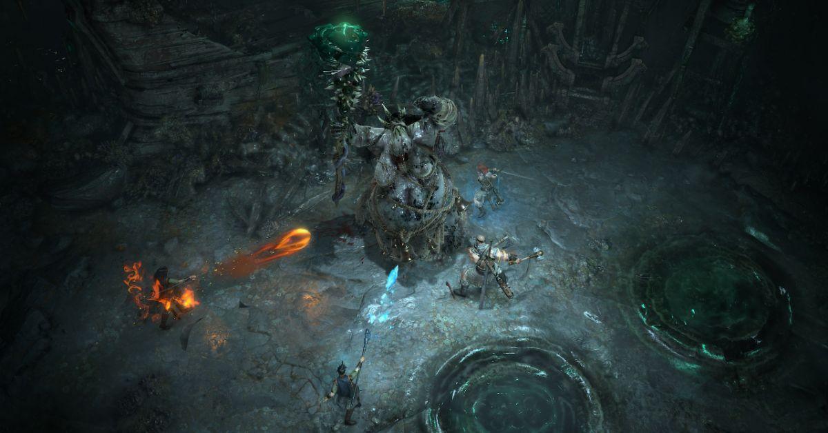 Diablo IV players attacking a boss inside a cave.