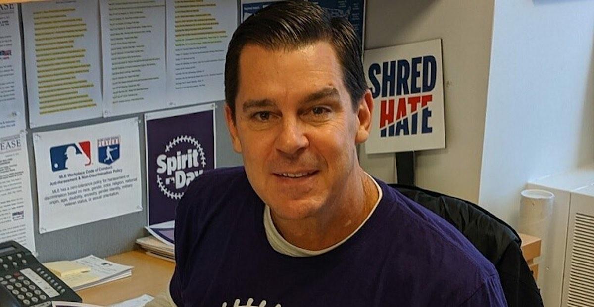 Billy Bean smiles at his desk in a 2019 Instagram post