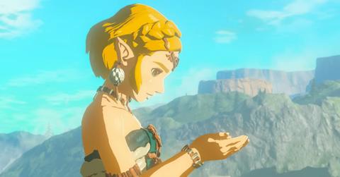 Zelda looking down at the palms of her hands in Tears of the Kingdom.
