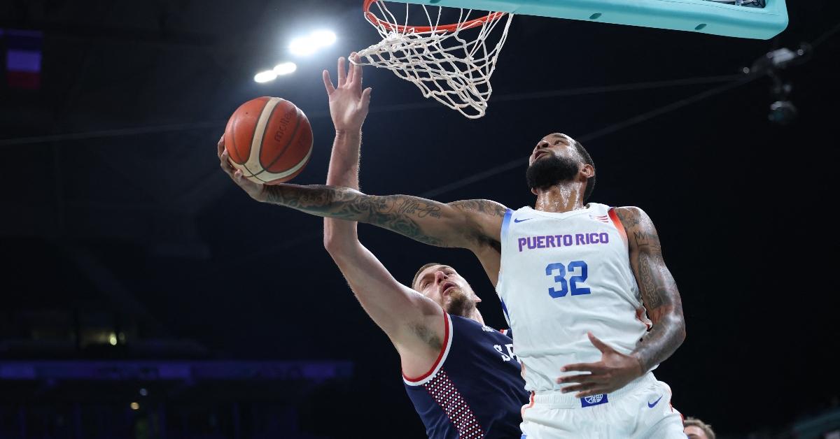 Puerto Rico's #32 Christopher Ortiz goes for a lay-up past Serbia's #15 Nikola Jokic in the men's preliminary round group C basketball match between Puerto Rico and Serbia during the Paris 2024 Olympic Games at the Pierre-Mauroy stadium in Villeneuve-d'Ascq, northern France, on July 31, 2024. (Photo by Thomas COEX / AFP) (Photo by THOMAS COEX/AFP via Getty Images)