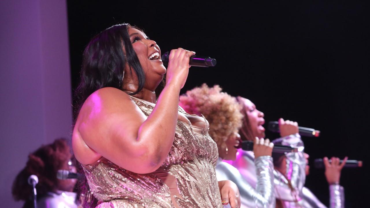 Lizzo singing at a VIP dinner party hosted by iHeartMedia and MediaLink on June 20, 2023, in France