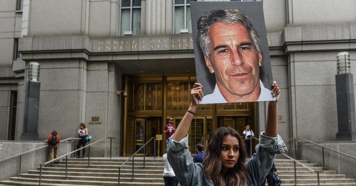  A protest group called "Hot Mess" hold up signs of Jeffrey Epstein in front of the federal courthouse on July 8, 2019, in New York City