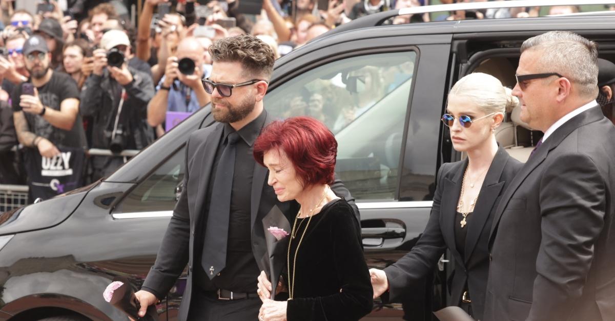 Jack Osbourne (L), Sharon Osbourne (center) and Kelly Osbourne (Right center) walk to Ozzy's memorial with flowers