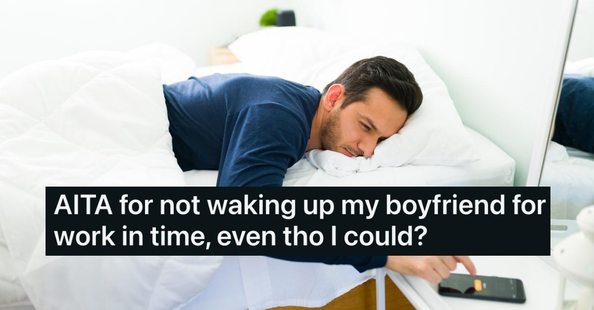 man in bed turning iphone alarm off