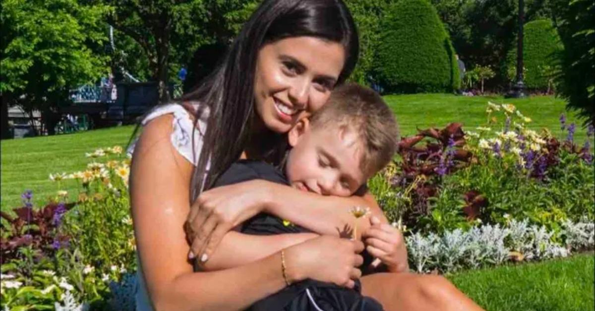 Bruna Ferreira with her son in a field.