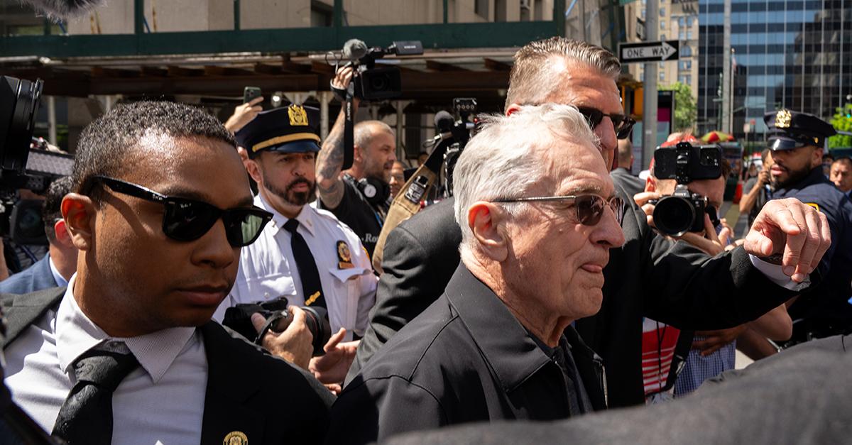 Robert DeNiro is called a mook while being escorted away from a news conference