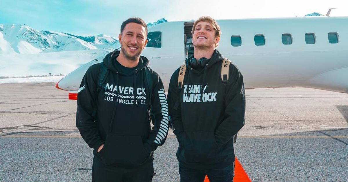 Logan Paul with friend Mike Maljak standing by a plane