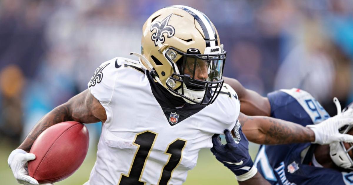 Deonte Harris #11 of the New Orleans Saints returns a kick off and stiff arms Monty Rice #56 of the Tennessee Titans at Nissan Stadium on November 14, 2021 in Nashville, Tennessee. 