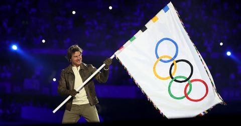 Tom Cruise waving the Olympic flag at the 2024 closing ceremonies.