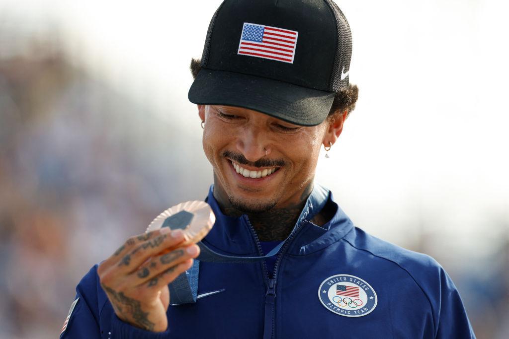 Nyjah Huston holding his bronze medal at the Olympics