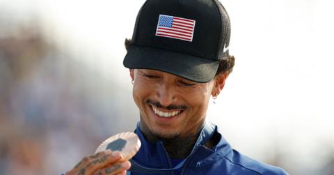Nyjah Huston holding his bronze medal at the Olympics