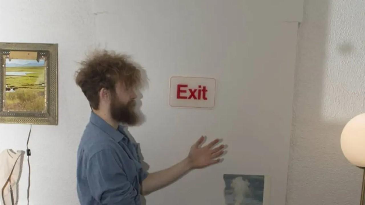 Jack Stauber standing near an exit sign