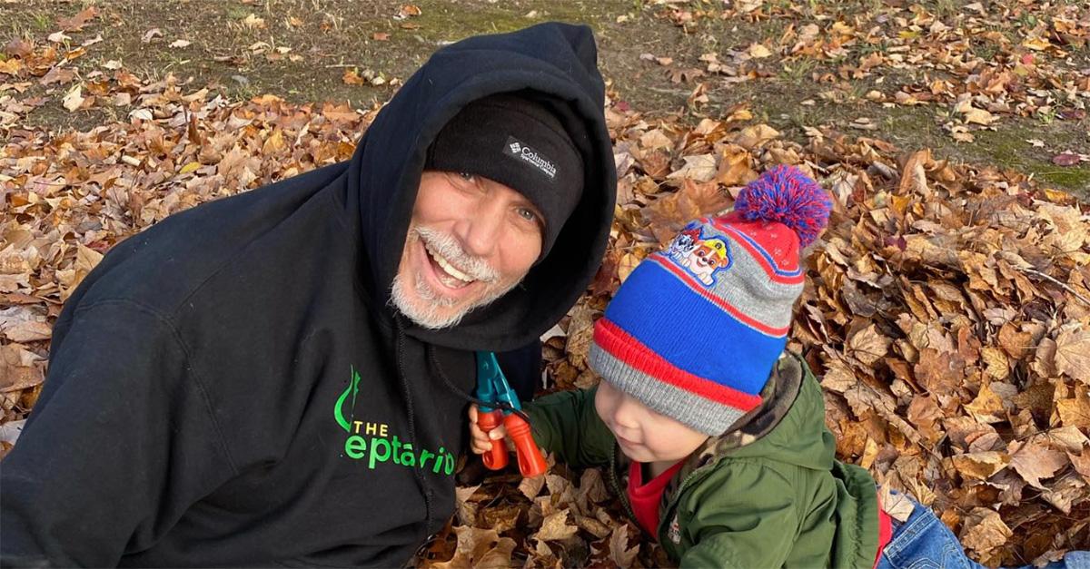 Brian Barczyk with his grandson playing in leaves. 