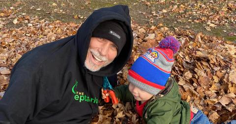 Brian Barczyk with his grandson playing in leaves.