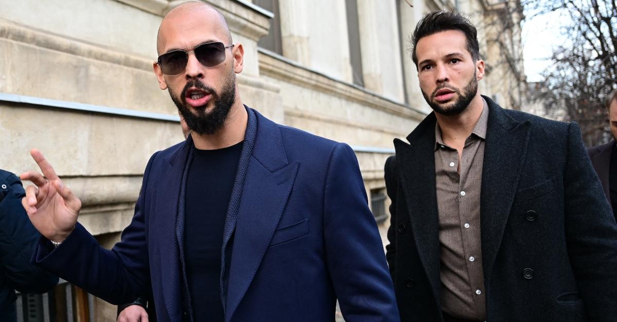 Andrew Tate (L) and Tristan Tate (R) walk from the Bucharest's Court of Appeal