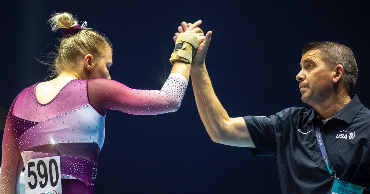 Jade Carey of the United States is congratulated by her father and coach Brian Carey.