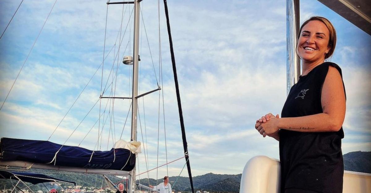 Daisy Kelliher's sister Bonnie Kelliher poses for an Instagram photo by a boat