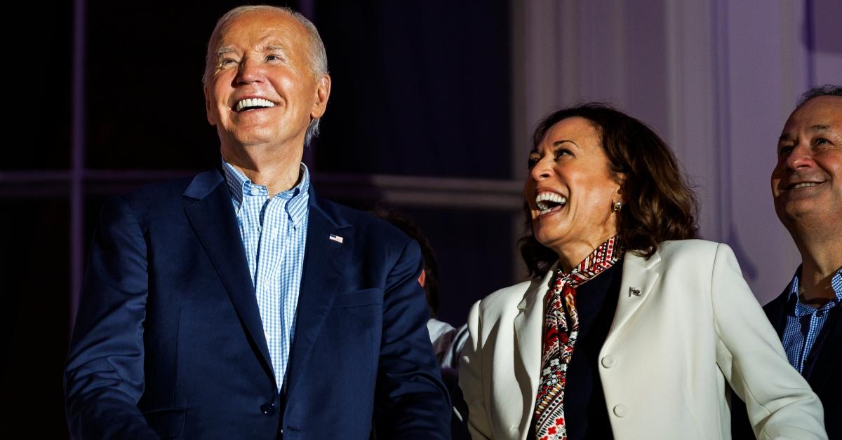 President Joe Biden and Vice President Kamala Harris laugh as they view the fireworks on the National Mall from the White House balcony during a 4th of July event on the South Lawn of the White House on July 4, 2024 in Washington, DC. The President is hosting the Independence Day event for members of the military and their families. (Photo by Samuel Corum/Getty Images)