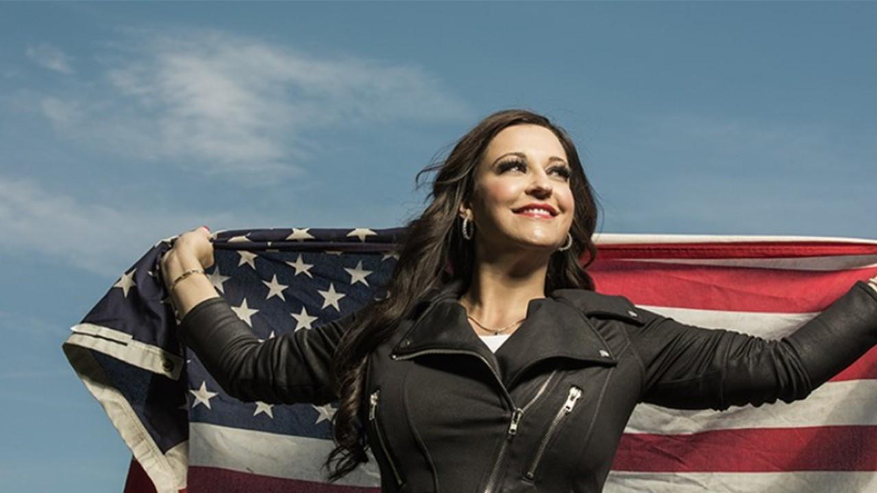 Natasha Owens holding an American flag