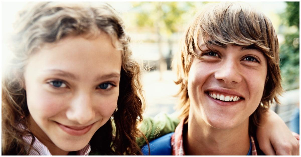 A teenage girl and boy smiling