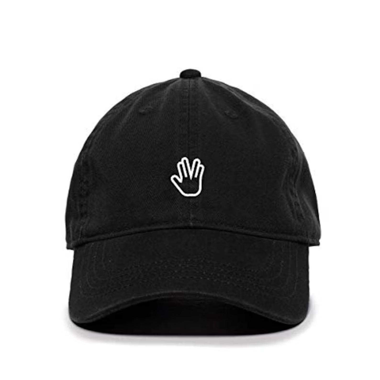 a black baseball cap with the long live and prosper hand gesture embroidered in white thread