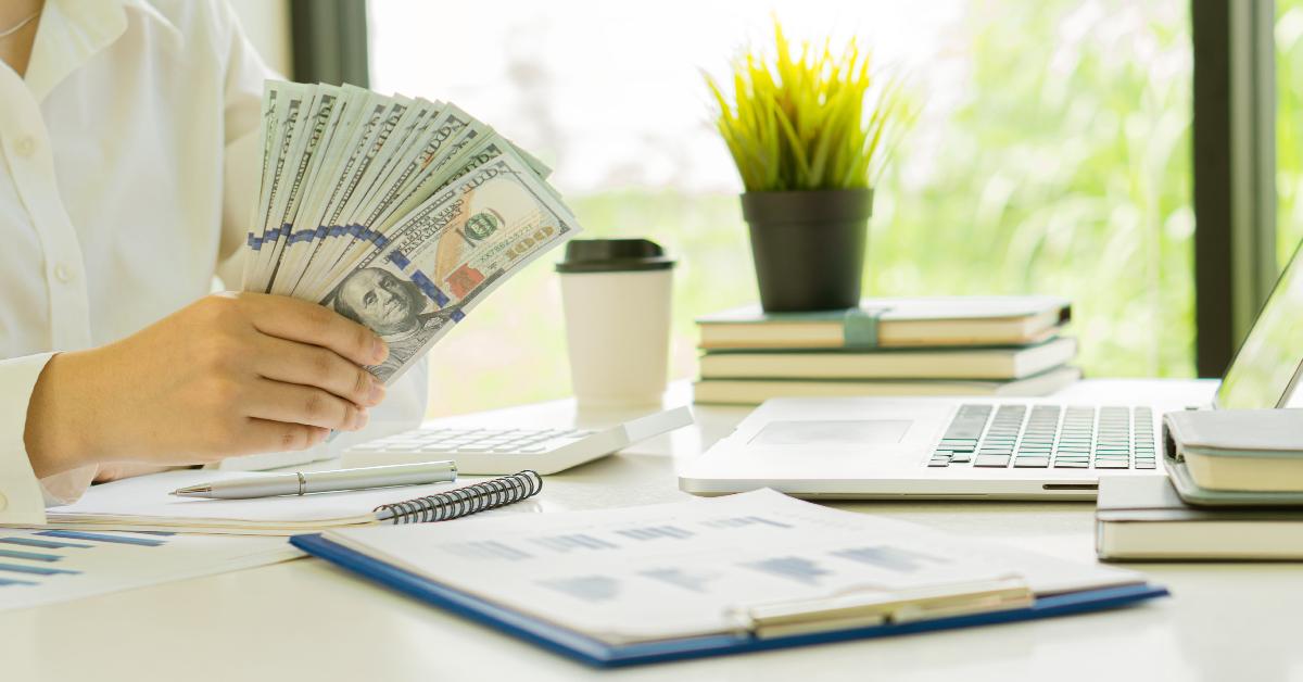 A businessman holding money.