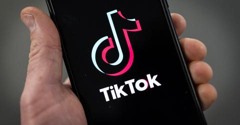 A person showing the TikTok logo on their phone