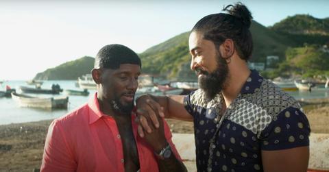 Carlos and VaLentine From ‘90 Day Fiancé: Love In Paradise’ hold hands on a beach